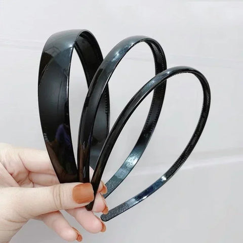 Zwarte modieuze golvende unisex haarband van kunststofhars - sportief haaraccessoire 